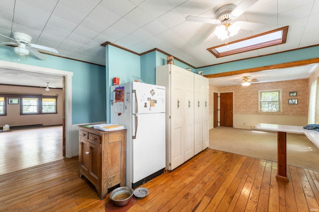 5668 E 500 S, Lynn, IN 47355 - kitchen featuring freestanding refrigerator, a ceiling fan, a skylight, and light wood finished floors