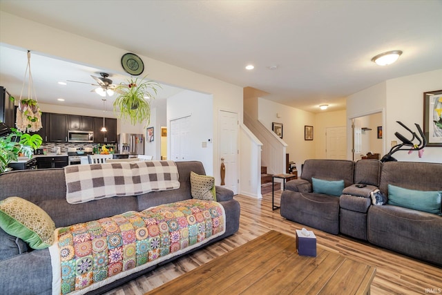 4671 W Hidden Meadow Dr, Bloomington, IN 47404 - living room featuring stairs, light wood-type flooring, ceiling fan, and recessed lighting