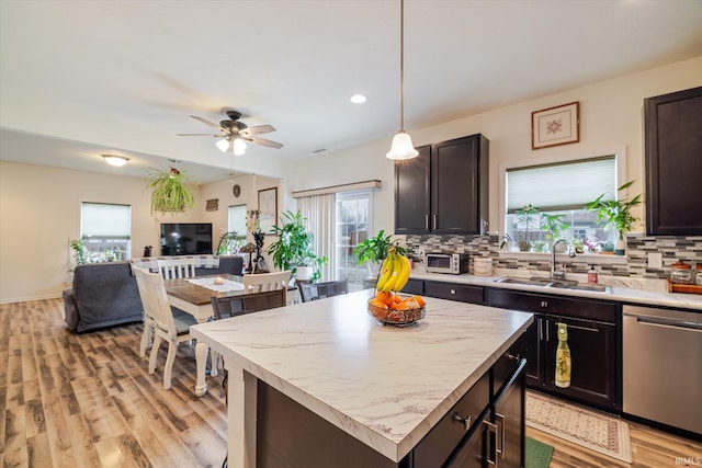 4671 W Hidden Meadow Dr, Bloomington, IN 47404 - kitchen featuring stainless steel dishwasher, plenty of natural light, a sink, open floor plan, and recessed lighting