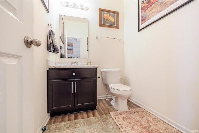 4671 W Hidden Meadow Dr, Bloomington, IN 47404 - half bathroom with wood finished floors, toilet, vanity, and baseboards