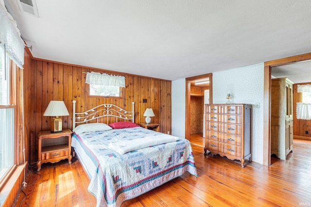9465 E 1000 N, Syracuse, IN 46567 - bedroom with light wood-style floors and wood walls