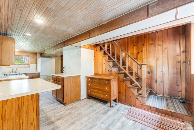 9465 E 1000 N, Syracuse, IN 46567 - kitchen with light countertops, brown cabinets, light wood finished floors, freestanding refrigerator, and wood ceiling