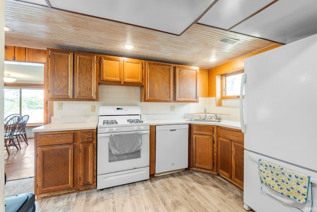 9465 E 1000 N, Syracuse, IN 46567 - kitchen with white appliances, a sink, light countertops, and decorative backsplash