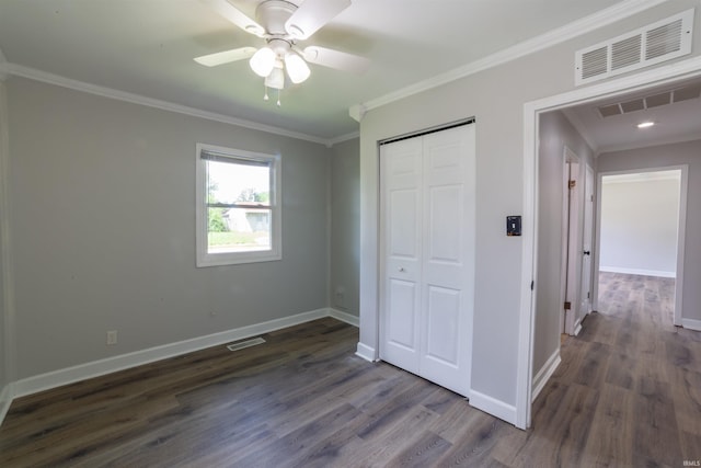 2067 Waggoner Ave, Evansville, IN 47714 - unfurnished bedroom featuring crown molding, baseboards, dark wood-style flooring, a closet, and ceiling fan