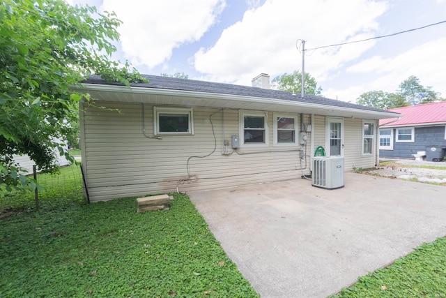 2067 Waggoner Ave, Evansville, IN 47714 - rear view of property with a patio area, a chimney, cooling unit, and a yard