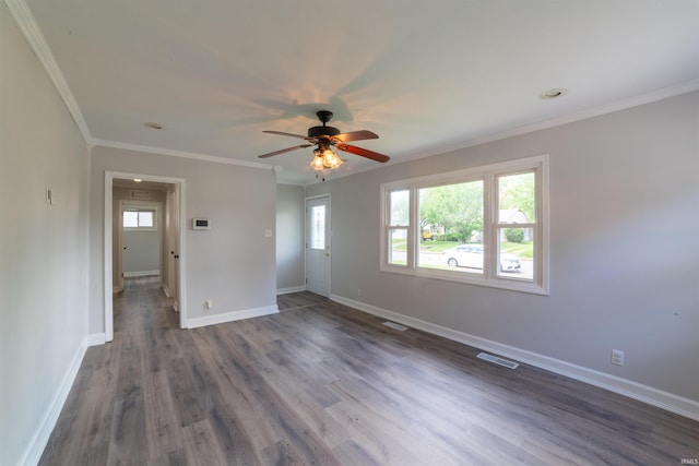 2067 Waggoner Ave, Evansville, IN 47714 - empty room featuring plenty of natural light, a ceiling fan, baseboards, dark wood-style floors, and ornamental molding