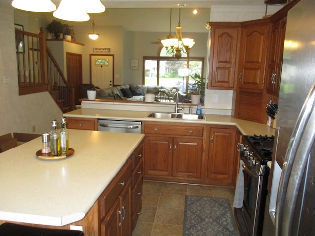 22715 Fair Oaks Ct, Elkhart, IN 46514 - kitchen with stainless steel appliances, a sink, a chandelier, light countertops, and open floor plan