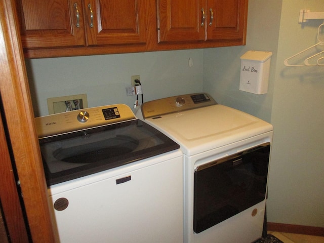 22715 Fair Oaks Ct, Elkhart, IN 46514 - laundry area with washer and clothes dryer and cabinet space