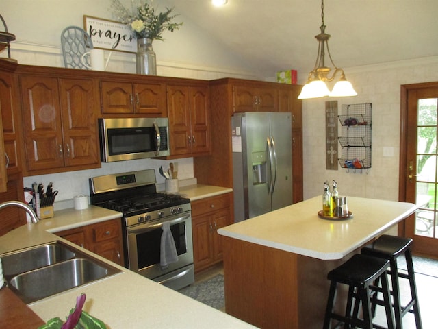22715 Fair Oaks Ct, Elkhart, IN 46514 - kitchen featuring appliances with stainless steel finishes, a sink, a kitchen island, light countertops, and brown cabinets