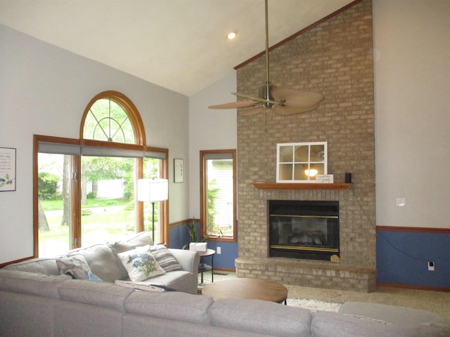 22715 Fair Oaks Ct, Elkhart, IN 46514 - living room with high vaulted ceiling, healthy amount of natural light, ceiling fan, a brick fireplace, and baseboards