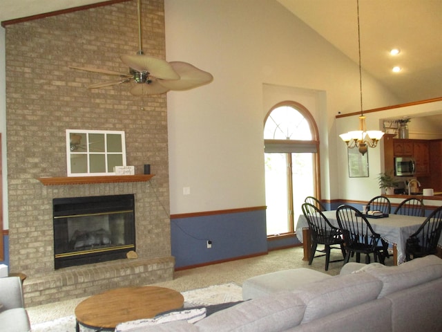22715 Fair Oaks Ct, Elkhart, IN 46514 - living area with high vaulted ceiling, ceiling fan, carpet flooring, a chandelier, and a fireplace