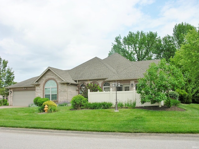 8036 Wolf Creek Ct, Evansville, IN 47712 - view of front of house with an attached garage, brick siding, roof with shingles, and concrete driveway