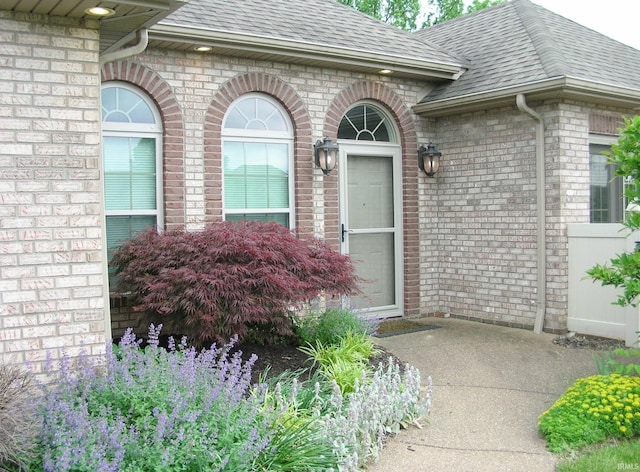 8036 Wolf Creek Ct, Evansville, IN 47712 - view of exterior entry featuring brick siding and a shingled roof