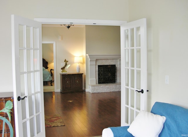 8036 Wolf Creek Ct, Evansville, IN 47712 - living area with wood-type flooring, a fireplace with raised hearth, and french doors