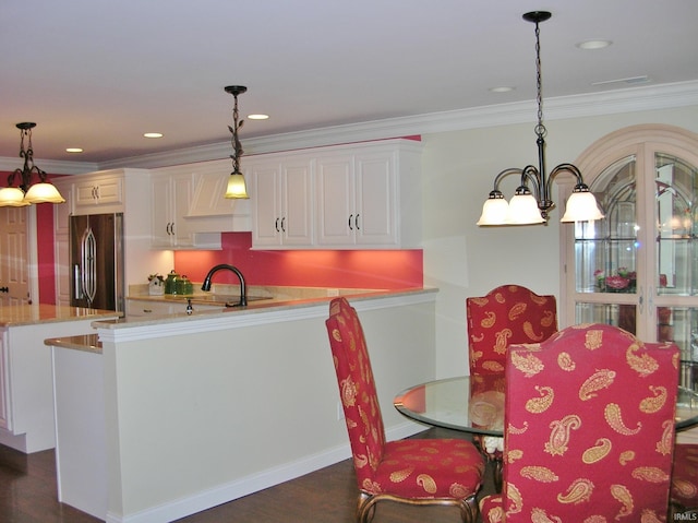 8036 Wolf Creek Ct, Evansville, IN 47712 - kitchen featuring freestanding refrigerator, light countertops, a chandelier, white cabinetry, and hanging light fixtures