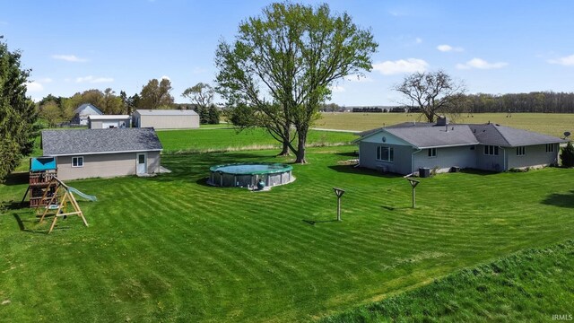 56915 Tulip Rd, New Carlisle, IN 46552 - view of grassy yard featuring a playground and a hot tub