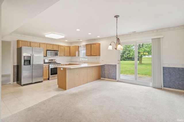 3260 E Sherman St, Columbia City, IN 46725 - kitchen with stainless steel appliances, a peninsula, light countertops, decorative light fixtures, and recessed lighting