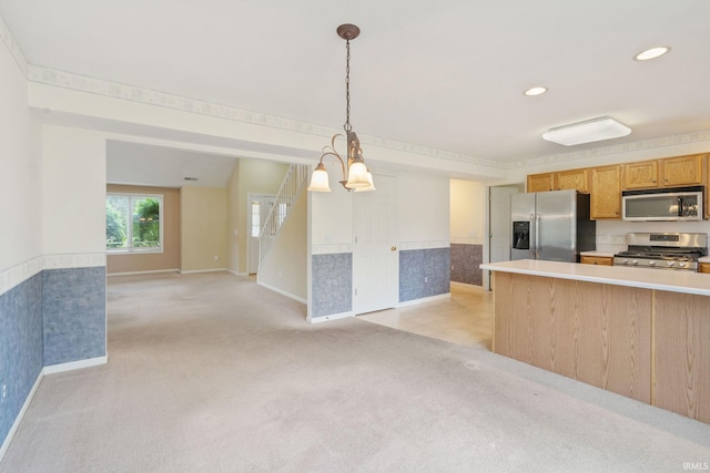3260 E Sherman St, Columbia City, IN 46725 - kitchen with appliances with stainless steel finishes, light carpet, baseboards, light countertops, and decorative light fixtures