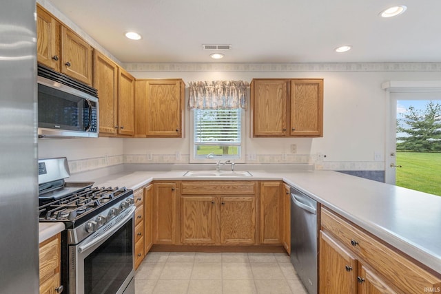 3260 E Sherman St, Columbia City, IN 46725 - kitchen featuring appliances with stainless steel finishes, a sink, recessed lighting, light countertops, and light tile patterned floors