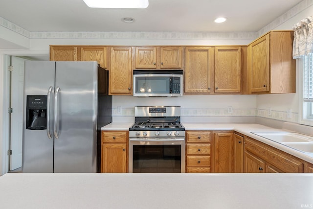 3260 E Sherman St, Columbia City, IN 46725 - kitchen featuring stainless steel appliances, light countertops, a sink, and recessed lighting