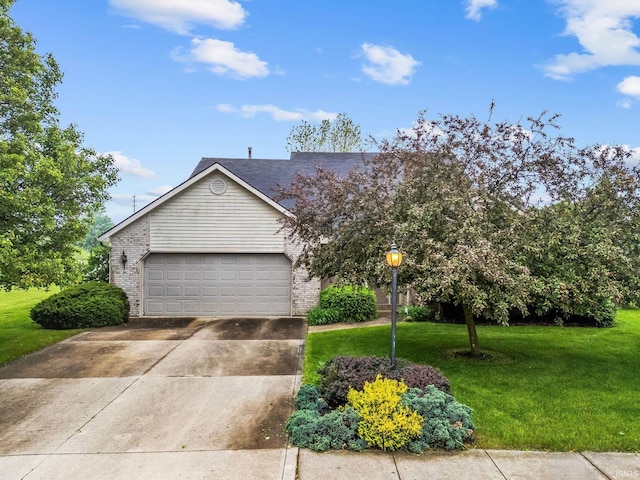 3260 E Sherman St, Columbia City, IN 46725 - view of front of property with a front lawn, brick siding, concrete driveway, and an attached garage