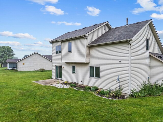 3260 E Sherman St, Columbia City, IN 46725 - rear view of property with a yard, a patio, and a shingled roof