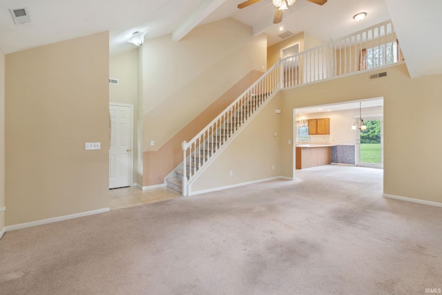 3260 E Sherman St, Columbia City, IN 46725 - unfurnished living room featuring stairs, high vaulted ceiling, carpet flooring, ceiling fan, and plenty of natural light