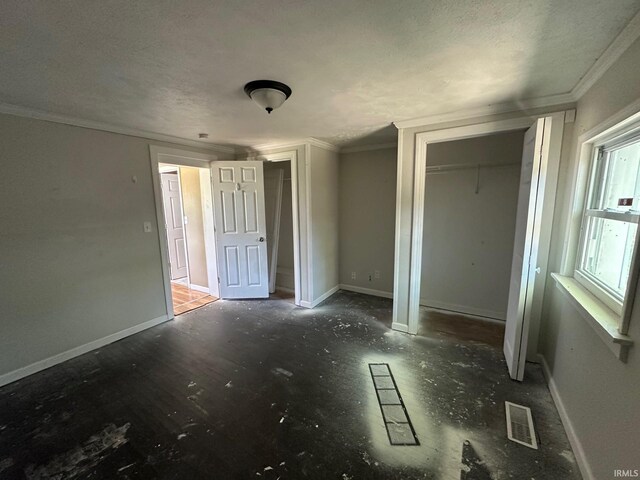 2118 Homewood Ave, Mishawaka, IN 46544 - unfurnished bedroom featuring a closet, crown molding, baseboards, and a textured ceiling