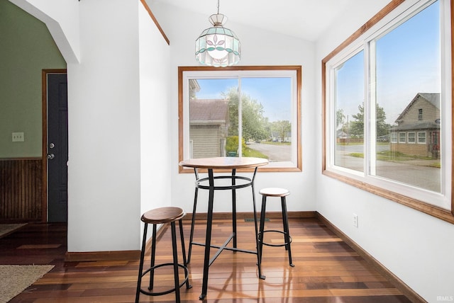 724 E Mishawaka Ave, Mishawaka, IN 46545 - dining space featuring lofted ceiling, dark wood-type flooring, arched walkways, and baseboards