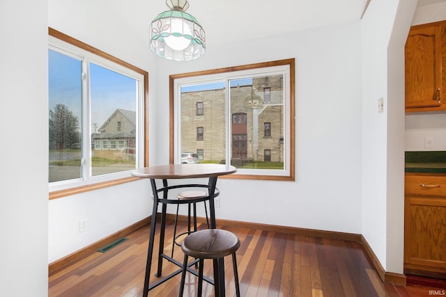 724 E Mishawaka Ave, Mishawaka, IN 46545 - dining space featuring plenty of natural light, dark wood-style flooring, and baseboards
