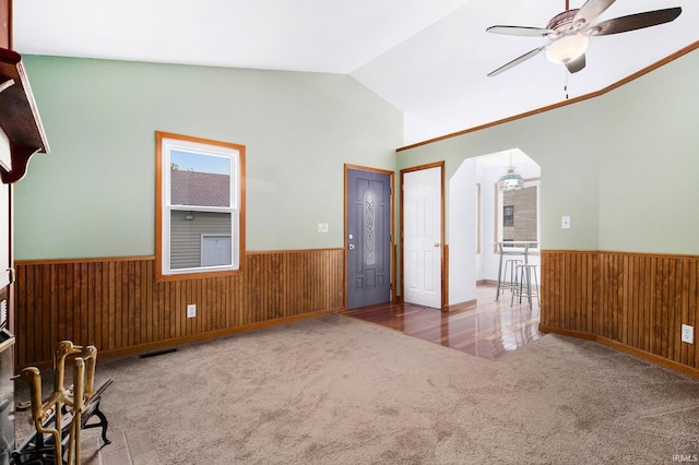 724 E Mishawaka Ave, Mishawaka, IN 46545 - carpeted spare room with wainscoting, lofted ceiling, wood walls, and ceiling fan