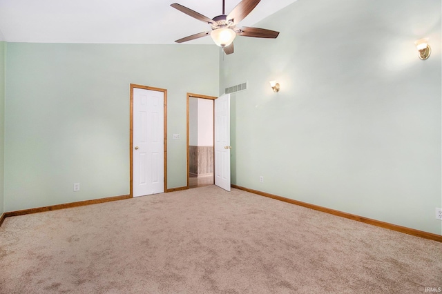724 E Mishawaka Ave, Mishawaka, IN 46545 - unfurnished bedroom featuring baseboards, light carpet, high vaulted ceiling, two closets, and ceiling fan
