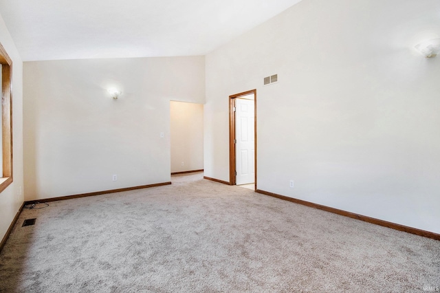 724 E Mishawaka Ave, Mishawaka, IN 46545 - spare room with light colored carpet, baseboards, and high vaulted ceiling
