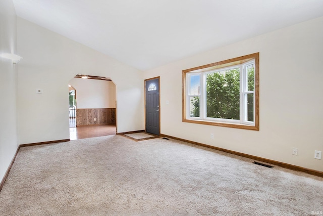 724 E Mishawaka Ave, Mishawaka, IN 46545 - unfurnished room with arched walkways, carpet flooring, lofted ceiling, and baseboards
