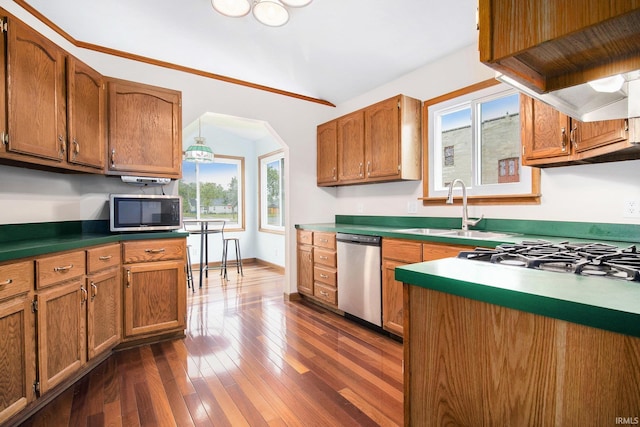 724 E Mishawaka Ave, Mishawaka, IN 46545 - kitchen with stainless steel appliances, a sink, brown cabinets, dark wood-type flooring, and arched walkways