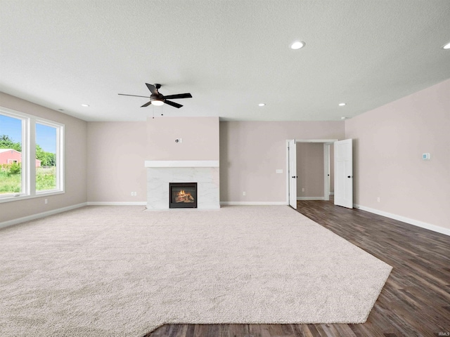 16927 Hillsong Ln, Huntertown, IN 46748 - unfurnished living room with a ceiling fan, baseboards, recessed lighting, a tiled fireplace, and dark wood finished floors