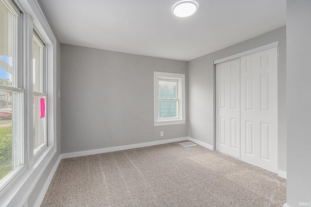 420 W 10th St, Mishawaka, IN 46544 - unfurnished bedroom featuring multiple windows and carpet flooring
