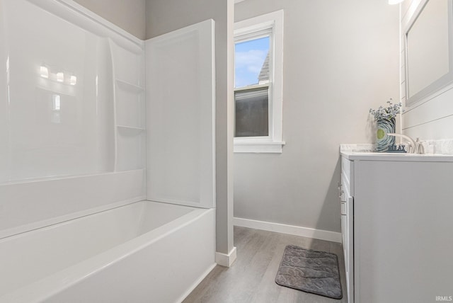 420 W 10th St, Mishawaka, IN 46544 - full bath with vanity, wood finished floors, baseboards, and  shower combination