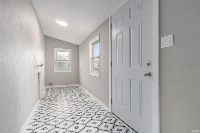 420 W 10th St, Mishawaka, IN 46544 - corridor featuring vaulted ceiling, light flooring, baseboards, and a textured wall