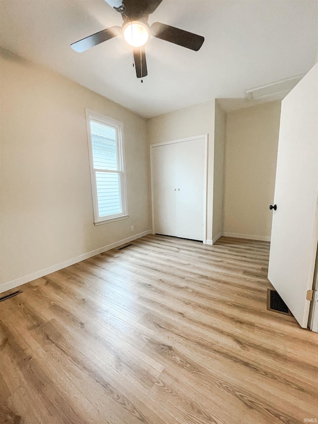 511 E 3rd St, Peru, IN 46970 - unfurnished bedroom with light wood-style floors, baseboards, and a ceiling fan