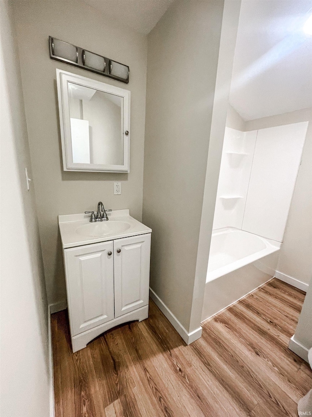 511 E 3rd St, Peru, IN 46970 - full bathroom with wood finished floors, baseboards, and vanity
