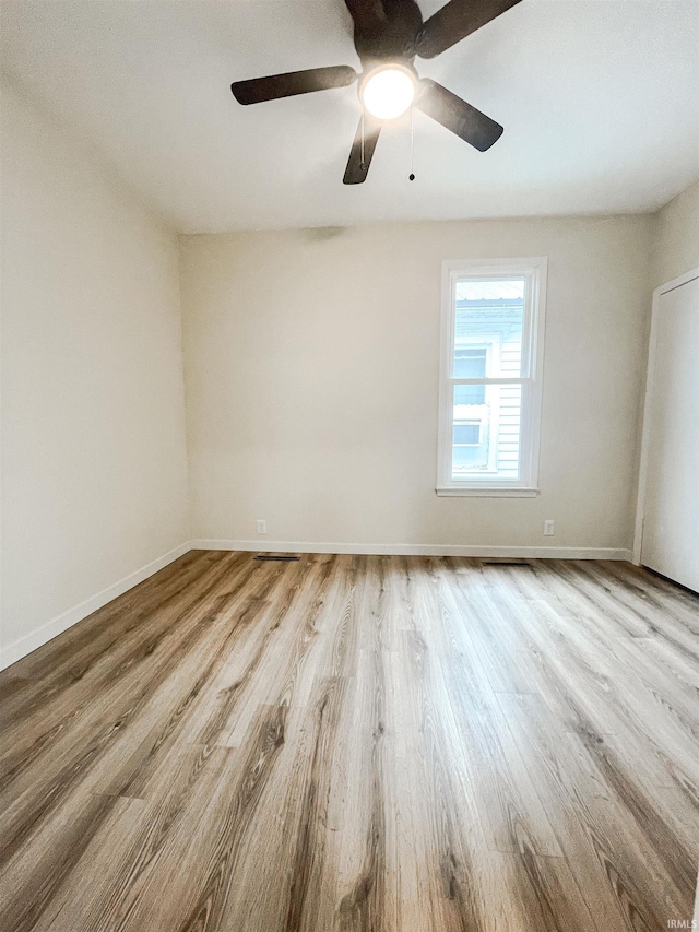 511 E 3rd St, Peru, IN 46970 - spare room featuring wood finished floors, baseboards, and ceiling fan