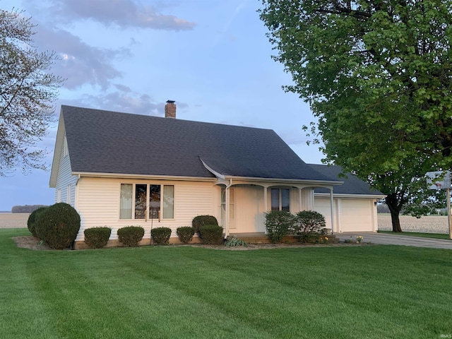 6921 Franke Rd, Fort Wayne, IN 46816 - view of front of house with a chimney, driveway, a front lawn, and an attached garage
