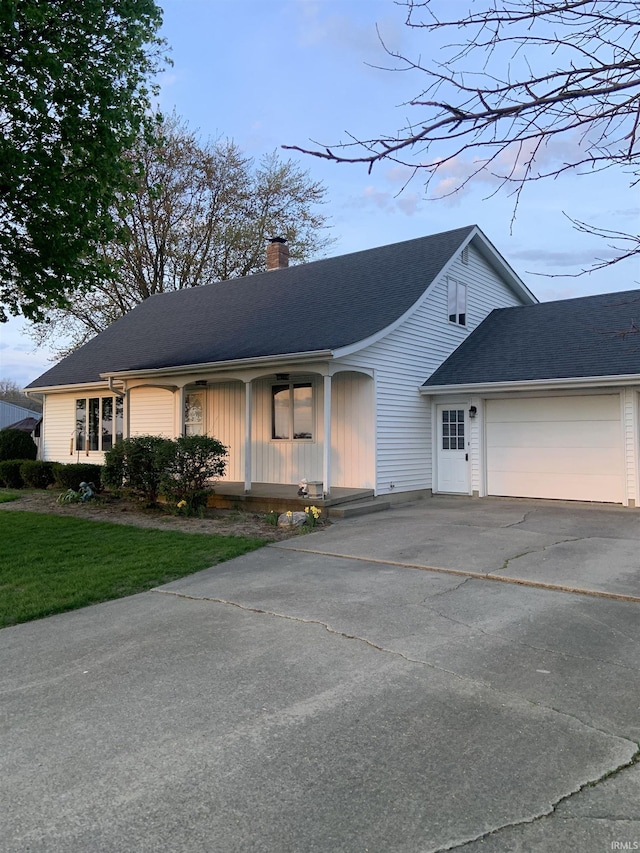 6921 Franke Rd, Fort Wayne, IN 46816 - view of front of house featuring driveway, an attached garage, a chimney, a front lawn, and roof with shingles