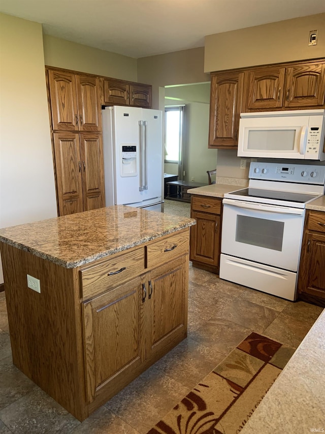 6921 Franke Rd, Fort Wayne, IN 46816 - kitchen with white appliances, brown cabinetry, a center island, and light stone countertops