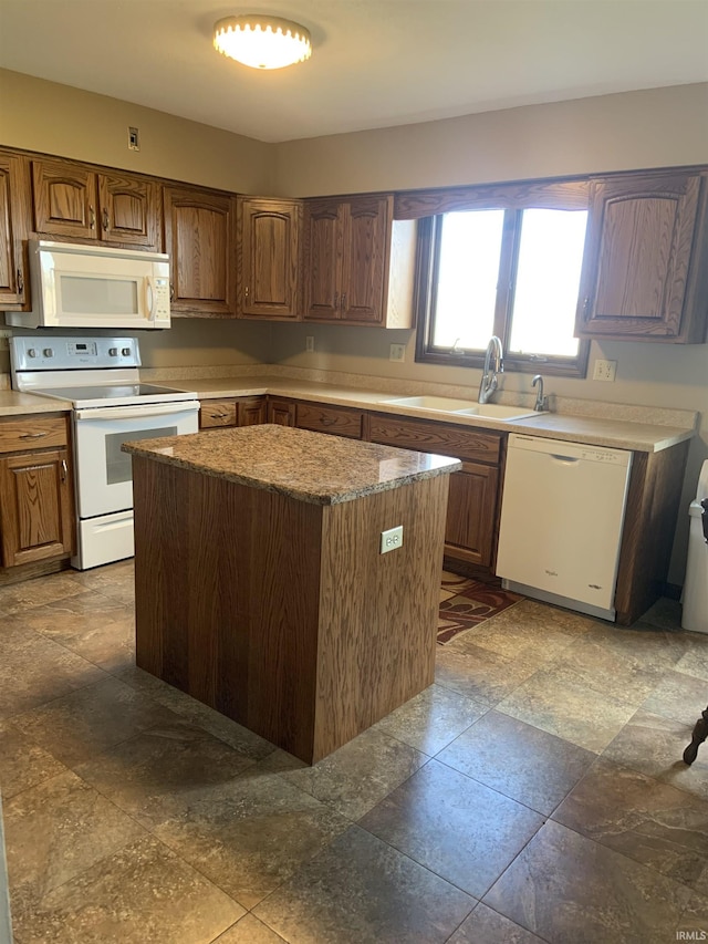 6921 Franke Rd, Fort Wayne, IN 46816 - kitchen featuring white appliances, a sink, a kitchen island, and brown cabinetry