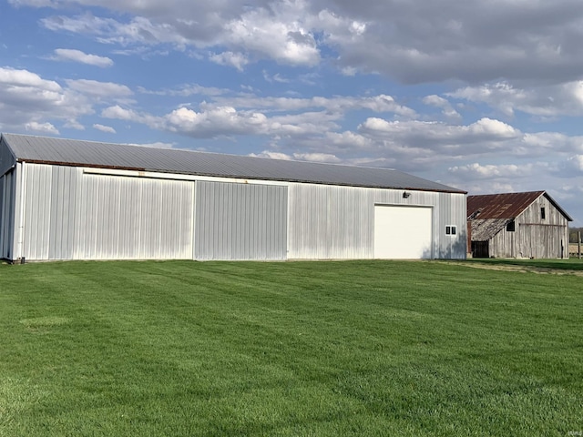 6921 Franke Rd, Fort Wayne, IN 46816 - view of green lawn with a pole building, a detached garage, and an outbuilding