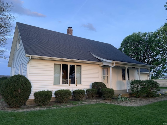 6921 Franke Rd, Fort Wayne, IN 46816 - view of front of property with a chimney, a front lawn, a garage, and roof with shingles