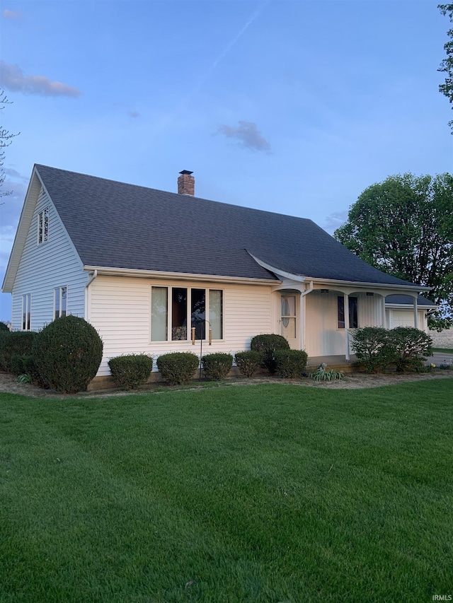 6921 Franke Rd, Fort Wayne, IN 46816 - view of front of home with a chimney, a front yard, and roof with shingles