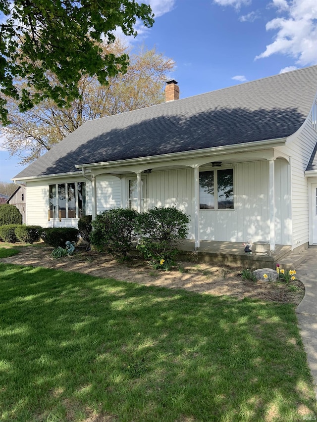 6921 Franke Rd, Fort Wayne, IN 46816 - ranch-style home featuring a chimney, a front yard, roof with shingles, and board and batten siding